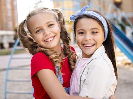 Smiling Two Girls Hugging Each Other