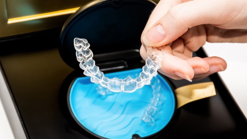 Transparent aligners in a box. Invisible braces. Clear teeth straighteners. Clear plastic bracers